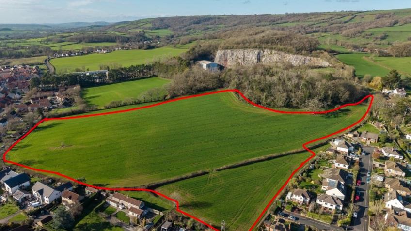 Aerial view of the proposed development site on Wells hillside, with the area outlined in red showing 5.38 hectares of green fields